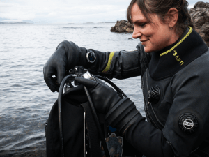Diver checking gauges and tank before a dive